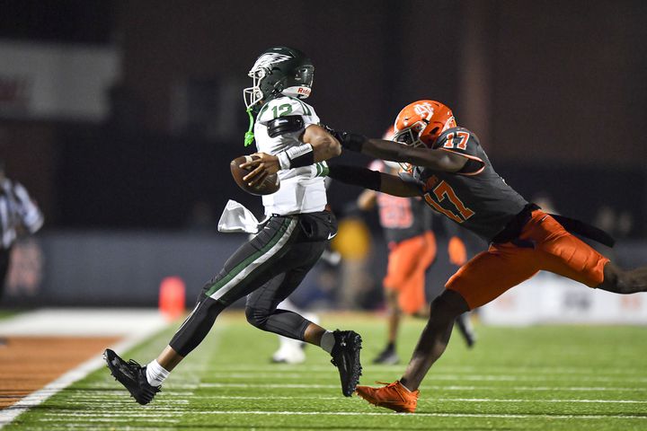 North Cobb James Askew (17) chases Collins Hill quarterback RJ Wilcox (12) out of bounds during the first half of play Friday, Nov. 10, 2023 at North Cobb High School. (Daniel Varnado/For the AJC)