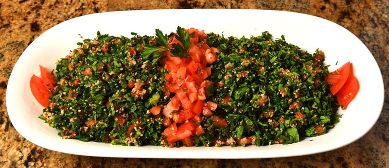 Tabbouleh, a bulgur salad, is a part of the meal that brings back memories for Hala Yassine: “Growing up, we would gather the parsley, mint and tomatoes for the tabbouleh and warak enab, stuffed grape leaves. It was a fun thing to do. We hunted. We gathered. We made.” (Styling by Farrah Haidar and Hala Yassine / Chris Hunt for the AJC)