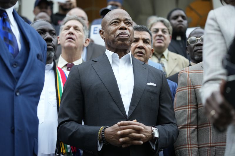 New York City Mayor Eric Adams is surrounded by faith leaders and other supporters during a rally and prayer vigil on the steps of City Hall in New York, Tuesday, Oct. 1, 2024. (AP Photo/Seth Wenig)