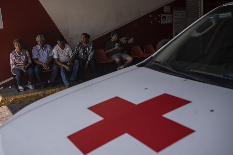 Family members of patients wait outside of the emergency services of the Mexican Red Cross in Veracruz, Mexico, Monday, June 17, 2024. Victims in Veracruz have made up nearly a third of Mexico's heat-related deaths as temperatures have reached 100 degrees in the humid Mexican gulf state. (AP Photo/Felix Marquez)