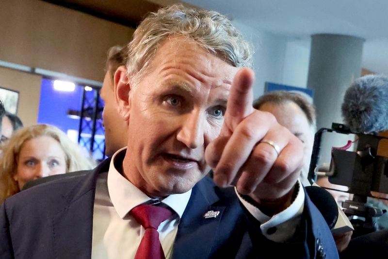 Bjoern Hoecke, top candidate in Thuringia of the far-right Alternative for Germany, gestures as he walks through the state parliament, in Erfurt, Germany, Sunday, Sept. 1, 2024. (Bodo Schackow/dpa via AP)