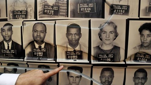 On the outside of a full-size replica of a Freedom Rider bus is a police mugshot of Congressman John Lewis, D-Ga., who was arrested many times during protests of the 1960s. The Freedom Rider exhibit is part of the civil rights gallery at the National Center for Civil and Human Rights, which opens Monday, June 23. DAVID TULIS / AJC Special