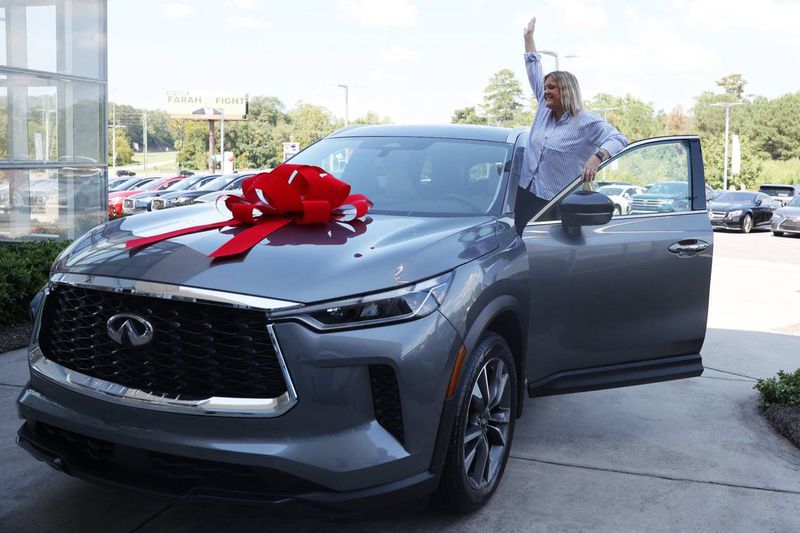 2025 Bibb County School District Teacher of the Year Sarah Mallett poses inside of her new car during the grand opening of Grand Infiniti on Saturday, Sept. 21, 2024, in Macon, Georgia. Mallett teaches at Howard Middle School and was awarded a year lease on a brand new Infiniti as a part of Grand Infiniti’s grand opening. (Photo Courtesy of Katie Tucker/The Telegraph)