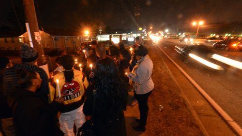 Family members and friends attend a vigil Friday, December 20, 2013, for 6-year-old Christopher Cook Jr., who was struck and killed while trying to cross Old National Highway outside of a crosswalk on Monday December 16. Police say he and his older brother were headed home to their apartment complex from a local barber shop. His incident is part of a troubling trend. The Georgia Department of Transportation has recorded 166 pedestrian fatalities so far this year — a 14% increase over the same time last year - and last year’s tally reflected an uptick as well. GDOT Commissioner Keith Golden said the spate of pedestrian deaths is concerning and “way out of whack” with other accident statistic trends.