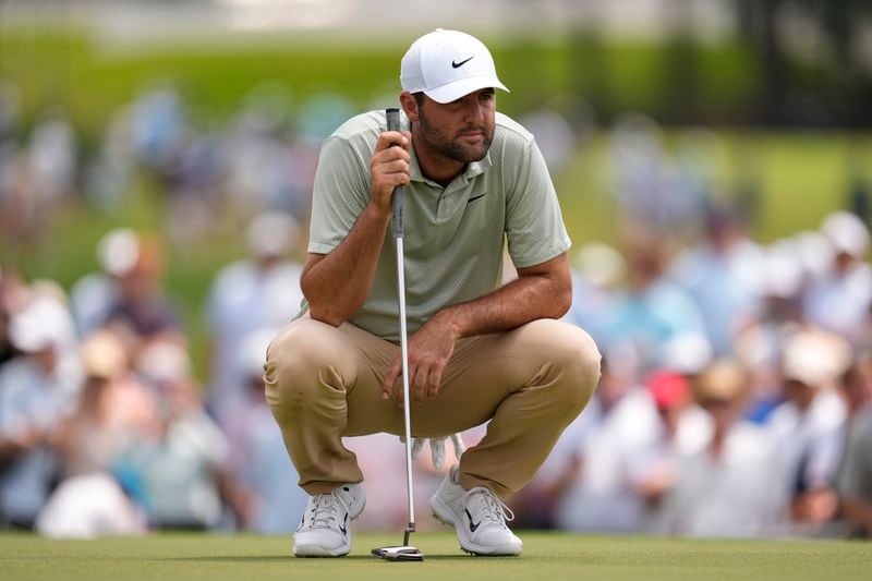 Scottie Scheffler lines up a putt on the third green during the final round of the Tour Championship golf tournament, Sunday, Sept. 1, 2024, in Atlanta. (AP Photo/Mike Stewart)