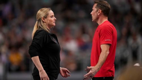 FILE - Cecile & Laurent Landi, coaches of Simone Biles, chat before she participates on the vault during the U.S. Gymnastics Championships, Sunday, June 2, 2024, in Fort Worth, Texas. The Landis are have a homecoming of sorts at the Paris Olympics when the French natives help lead Biles and a U.S. women's gymnastics team heavily favored to win gold. (AP Photo/Julio Cortez, File)