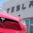 FILE - A Model X sports-utility vehicle sits outside a Tesla store in Littleton, Colo., June 18, 2023. (AP Photo/David Zalubowski, File)