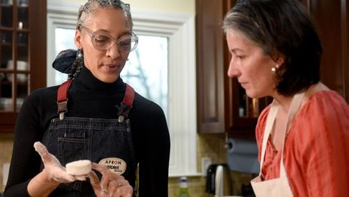 February 22, 2019 Atlanta - Top Chef Carla Hall (left) shows the AJCâs Ligaya Figueras (right) the texture of a good biscuit. Ligaya hosted Hall and food expert Chadwick Boyd at her home, where the two shared tips with Ligaya on how to make the best biscuits. RYON HORNE / RHORNE@AJC.COM