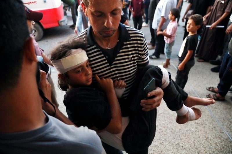 A Palestinian child wounded in an Israeli bombardment on a residential building owned by the Jabr family in Bureij refugee camp, is brought to al-Aqsa Martyrs Hospital in Deir al Balah, central Gaza Strip, Wednesday, June 12, 2024. (AP Photo/Saher Alghorra)