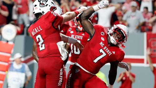 North Carolina State running back Jordan Waters (7) celebrates his touchdown with teammates against Western Carolina during the second half of an NCAA college football game in Raleigh, N.C., Thursday, Aug. 29, 2024. (AP Photo/Karl B DeBlaker)