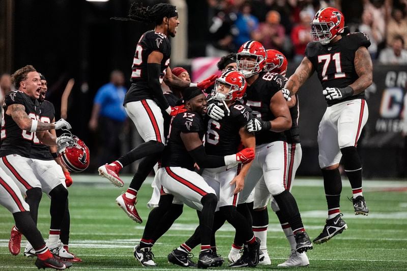 Atlanta Falcons players celebrate place kicker Younghoe Koo's game-winning 58-yard-field goal against the New Orleans Saints during the second half of an NFL football game, Sunday, Sept. 29, 2024, in Atlanta. (AP Photo/John Bazemore)