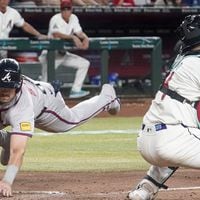 Austin Riley scores the winning run in the 11th inning of Monday's win over the Diamondbacks.