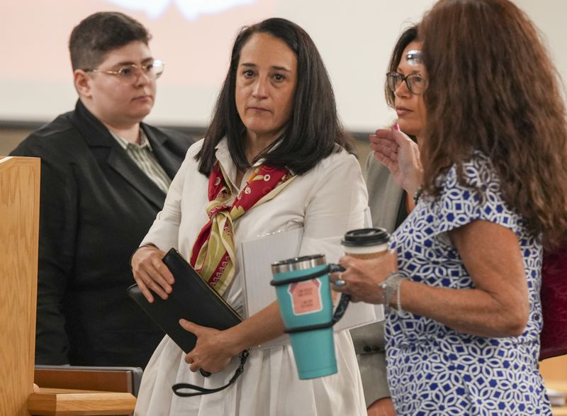 Renata Rojas, OceanGate mission specialist, center, pauses during at the Titan marine board formal hearing, inside the Charleston County Council Chambers, Thursday, Sept. 19, 2024, in North Charleston, S.C. (Corey Connor via AP, Pool)