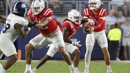 Mississippi quarterback Jaxson Dart, right, hands the ball to running back Matt Jones (0) during the first half of an NCAA college football game against Georgia Southern, Saturday, Sept. 21, 2024, in Oxford, Miss. (AP Photo/Sarah Warnock)