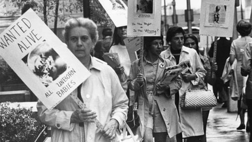 Anti-abortion protestors picket along a sidewalk in downtown Atlanta in 1971. That year, there were 1,580 recorded legal abortions in Georgia, as allowed by the state's 1968 abortion law.  (Charles Pugh / AJC archive at GSU Library AJCP178-009i)