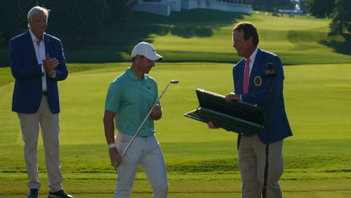 Chuck Palmer presents Rory McIlroy with a replica of Bobby Jones' putter Calamity Jane after his Tour Championship victory last year.