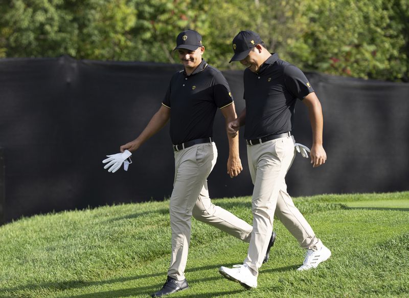 International team members Christiaan Bezuidenhout, of South Africa, left, and Si Woo Kim of South Korea, walk the fairway on the fourth hole during practice at the Presidents Cup golf tournament at Royal Montreal Golf Club in Montreal, Tuesday, Sept. 24, 2024. (Christinne Muschi/The Canadian Press via AP)