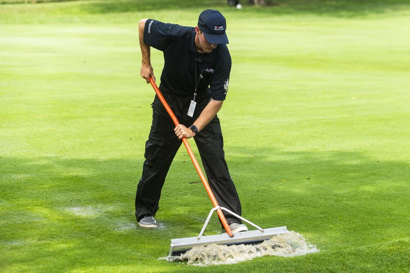 Crews work to remove water from the course after heavy rains before third round of the PGA Rocket Mortgage Classic golf tournament, Saturday, June 29, 2024, at the Detroit Golf Club in Detroit. (Katy Kildee/Detroit News via AP)