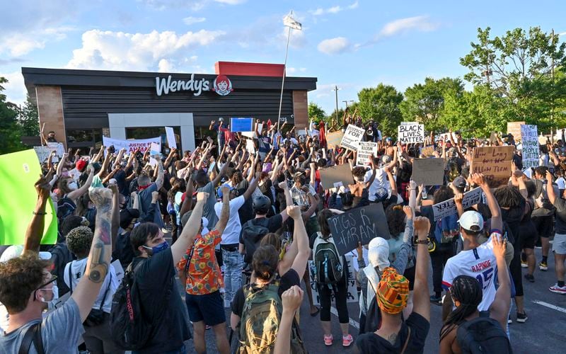 Protesters gather on Saturday, June 13, 2020, at the Atlanta Wendy's where Rayshard Brooks, a 27-year-old black man, was shot and killed by Atlanta police on Friday evening during a struggle in a Wendy's drive-thru line.  Hyosub Shin / hyosub.shin@ajc.com