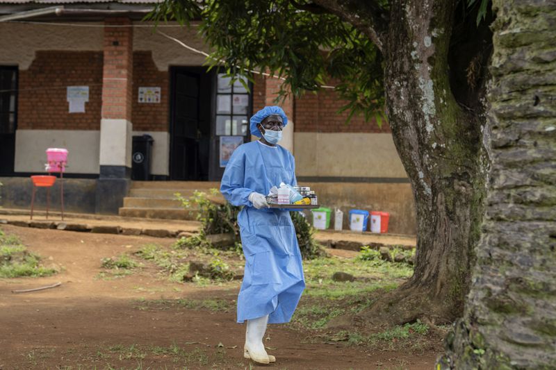 A health worker carries medication to be giving to a man suffering for mpox at the Kamituga General Hospital in South Kivu Congo, Wednesday, Sept. 4, 2024. (AP Photo/Moses Sawasawa)