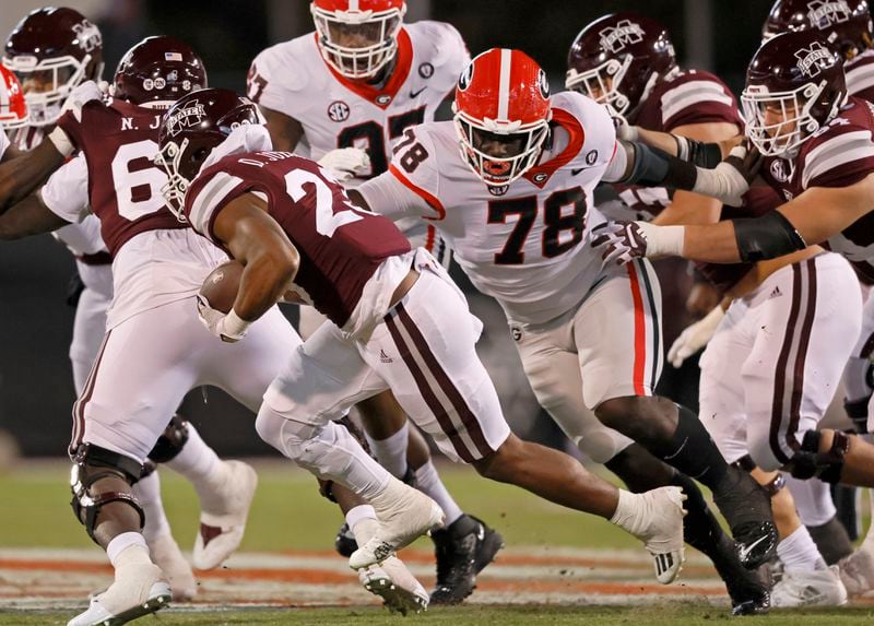 Georgia defensive lineman Nazir Stackhouse (78) pursues Mississippi State Bulldogs running back Dillon Johnson (23) during their game at Davis Wade Stadium, Saturday, November 12, 2022, in Starkville, Mississippi. Georgia won 45-17. Jason Getz / Jason.Getz@ajc.com)