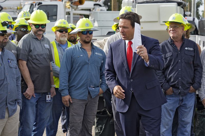 Florida Gov. Ron DeSantis, second from right, speaks to linemen before a news conference, Wednesday, Sept. 25, 2024, at the Tampa Electric Company offices in Tampa, Fla., as Tropical Storm Helene, expected to become a hurricane, moves north along Mexico’s coast toward the U.S. (AP Photo/Chris O'Meara)