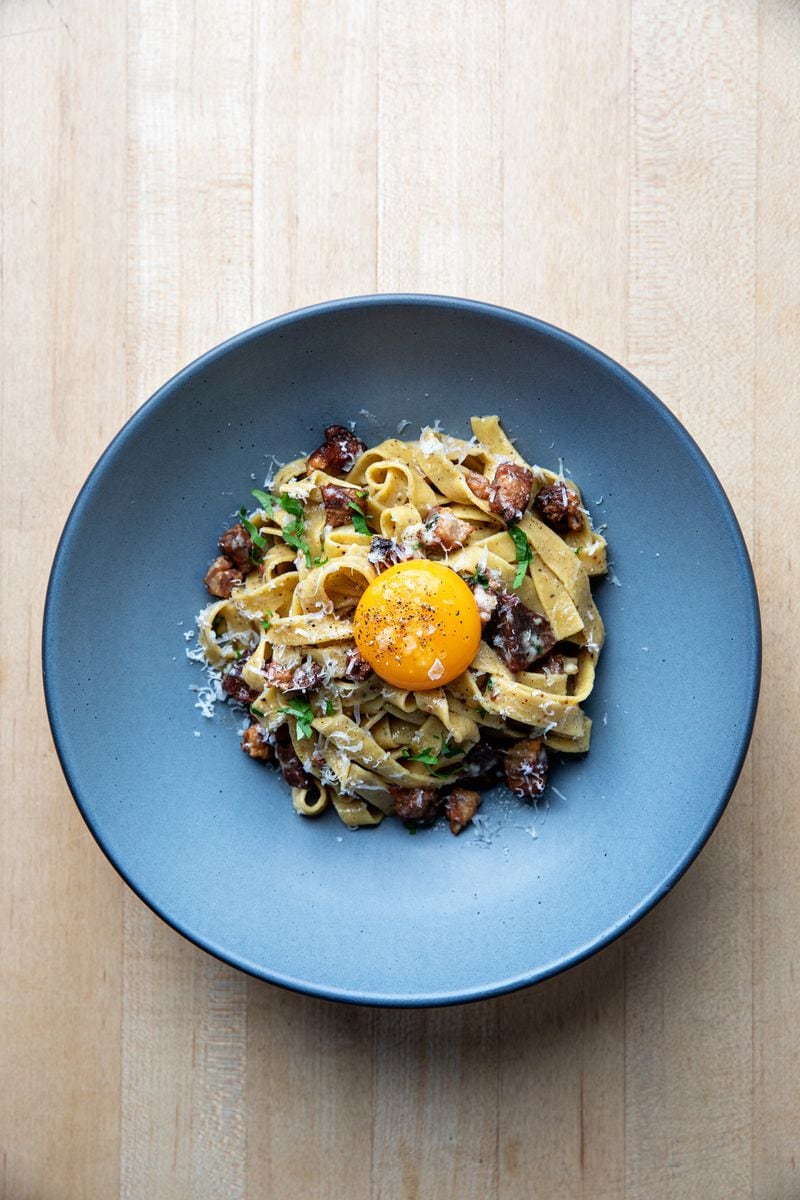 Black pepper tagliatelle at Indaco was studded with cubes of cured pork belly and topped with an egg yolk. Courtesy of Andrew Cebulka