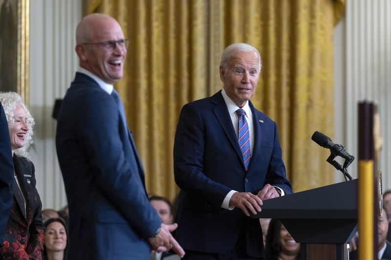 President Joe Biden speaks as University of Connecticut Men's Basketball Team Coach Dan Hurley laughs in the East Room of the White House in Washington, Tuesday, Sept. 10, 2024, during an event to welcome University of Connecticut Huskies Men's Basketball Team to celebrate their 2023-2024 NCAA championship season. (AP Photo/Jose Luis Magana)