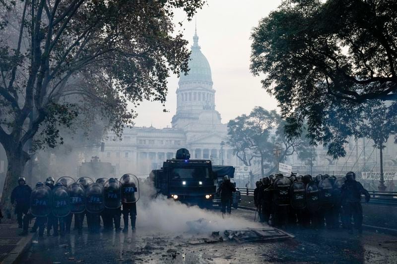 Police clear the streets during clashes with anti-government protesters outside Congress, where lawmakers debate a reform bill promoted by Argentine President Javier Milei in Buenos Aires, Argentina, Wednesday, June 12, 2024. (AP Photo/Rodrigo Abd)
