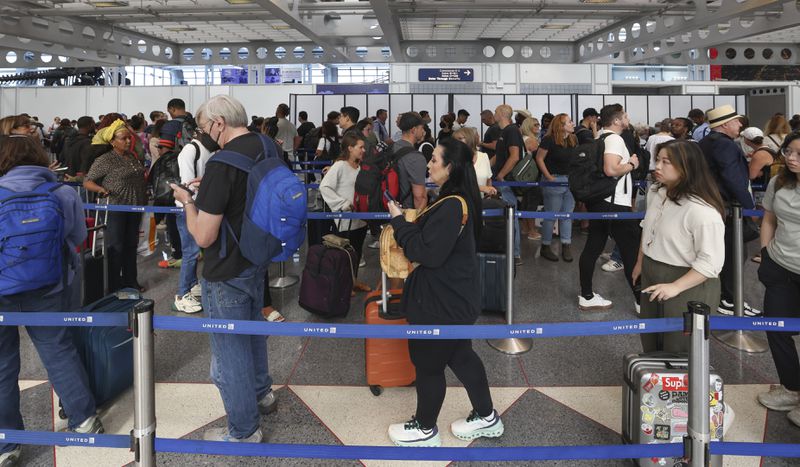 Travelers stand in a security line at O'Hare International Airport in Chicago on Friday, Aug. 30, 2024. (AP Photo/Teresa Crawford)