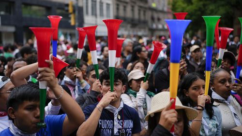 People blows vuvuzelas during a rally in favor of the government's proposed judicial reform outside the Supreme Court building in Mexico City, Thursday, Sept. 5, 2024. (AP Photo/Eduardo Verdugo)