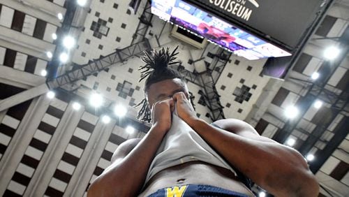 Wheeler's Isaiah Collier can’t hide his emotion as teammates celebrate their win over Cherokee during 2023 GHSA Basketball Class 7A Boy’s State Championship game at the Macon Centreplex, Saturday, March 11, 2023, in Macon, GA. (Hyosub Shin / Hyosub.Shin@ajc.com)