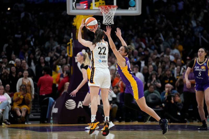 Indiana Fever guard Caitlin Clark (22) makes a 3-pointer during the second half of a WNBA basketball game against the Los Angeles Sparks in Los Angeles, Friday, May 24, 2024. (AP Photo/Ashley Landis)