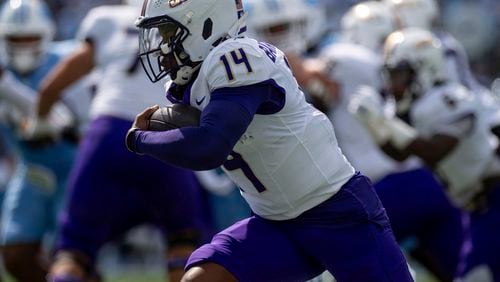 James Madison quarterback Alonza Barnett III (14) drives the ball around North Carolina defense during the first half of an NCAA college football game in Chapel Hill, N.C., Saturday, Sept. 21, 2024. (Daniel Lin/Daily News-Record via AP)