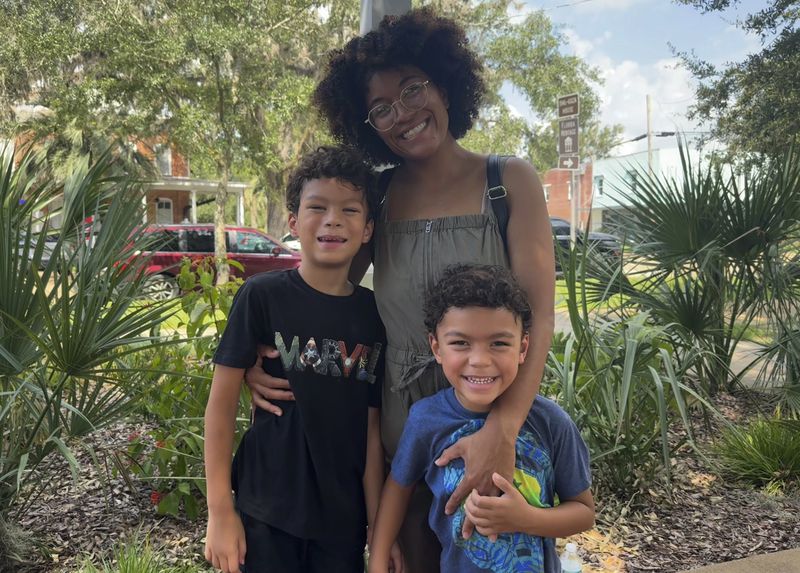 Alexis Molden poses for a photo with her sons Alex'zae, left, and Dimitri, right, in Madison, Fla. on Aug. 10, 2024. (AP Photo/Kate Payne)