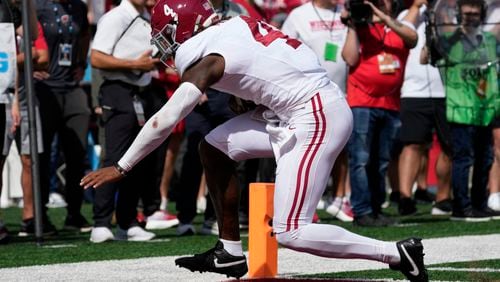 Alabama's Jalen Milroe (4) runs for a touchdown during the first half of an NCAA college football game against Wisconsin Saturday, Sept. 14, 2024, in Madison, Wis. (AP Photo/Morry Gash)