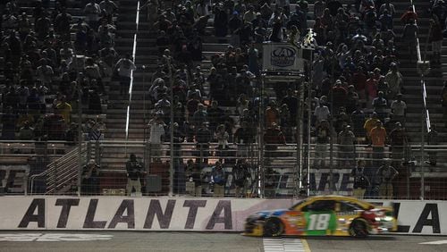 Kyle Busch crosses the finish line to win the Advocare 500 at Atlanta Motor Speedway on Sunday, September 1, 2013.  JOHNNY CRAWFORD / AJC file