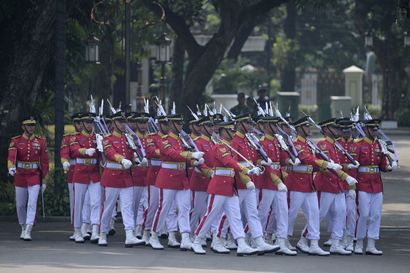 Members of an honour guard march to positions ahead of the ceremonial welcome for Pope Francis at the Presidential Palace in Jakarta Wednesday, Sept. 4, 2024. (Bay Ismoyo/Pool Photo via AP)