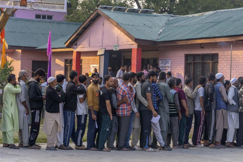 Kashmiri's queue up at a polling booth to cast their vote during the second phase of the assembly election in the outskirts of Srinagar, Indian controlled Kashmir, Wednesday, Sept. 25, 2024. (AP Photo/Dar Yasin)