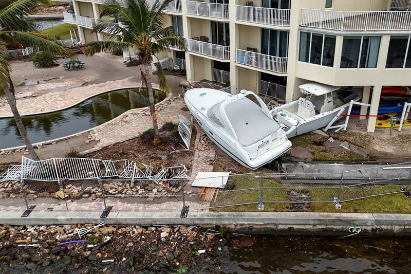 Boats sit after being pushed ashore by floodwaters from Hurricane Helene on Saturday, Sept. 28, 2024, in St. Petersburg, Fla. (AP Photo/Mike Carlson)