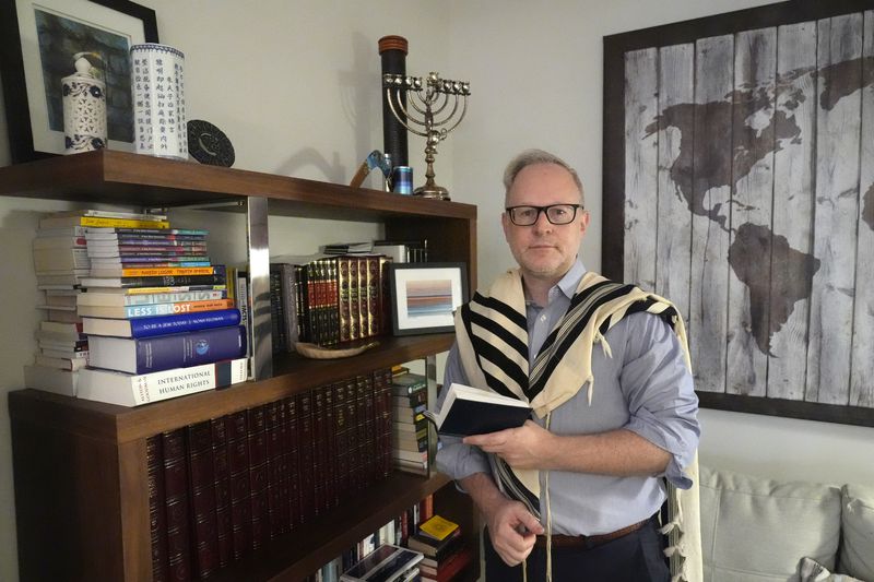 Daniel Gammerman poses for a photo in his home where he plans to worship privately during the Jewish High Holy Days, Thursday, Sept. 26, 2024, in Miami. (AP Photo/Wilfredo Lee)