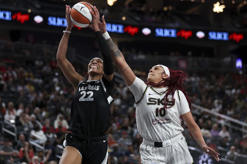 Las Vegas Aces center A'ja Wilson (22) shoots and is fouled by Chicago Sky center Kamilla Cardoso (10) during the second half of an WNBA basketball game, Tuesday, Sept. 3, 2024, in Las Vegas. L (Ellen Schmidt/Las Vegas Sun via AP)