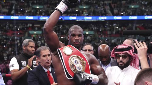 Daniel Dubois, center, celebrates victory against Anthony Joshua, not pictured, in the IBF World Heavyweight bout at Wembley Stadium, in London, Saturday, Sept. 21, 2024. (Bradley Collyer/PA via AP)