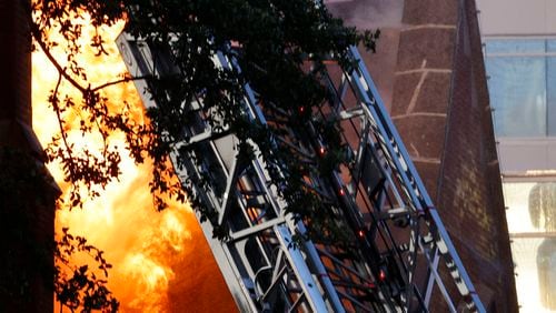 Firefighters battle a fire at First Baptist Dallas church on Friday, July 19, 2024, in Dallas. (Chitose Suzuki/The Dallas Morning News via AP)