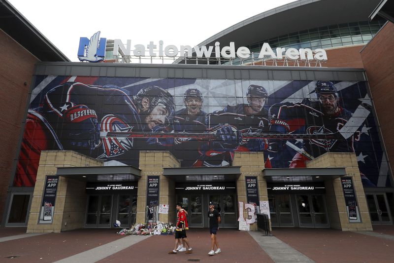 Nationwide Arena displays a memorial set up by fans for Blue Jackets hockey player Johnny Gaudreau in Columbus, Ohio, Aug. 30, 2024. Gaudreau, along with his brother Matthew, was fatally struck by a motorist while riding his bicycle on Thursday. (AP Photo/Joe Maiorana)