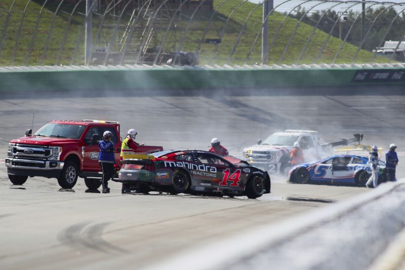 Chase Briscoe (14) is involved in a wreck with Kyle Larson (5) around Turn 2 during a NASCAR Cup Series auto race Sunday, Sept. 8, 2024, in Hampton, Ga. (AP Photo/Greg McWilliams)