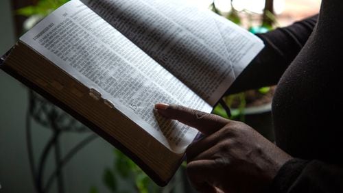 A client of the federal Housing Opportunities for Persons with AIDS program reads her mother's bible at the Ellenwood house where she was staying Sunday, December 23, 2021. She is homeless after her case fell through the cracks of the city of Atlanta-run program. STEVE SCHAEFER FOR THE ATLANTA JOURNAL-CONSTITUTIONSTEVE SCHAEFER FOR THE ATLANTA JOURNAL-CONSTITUTION