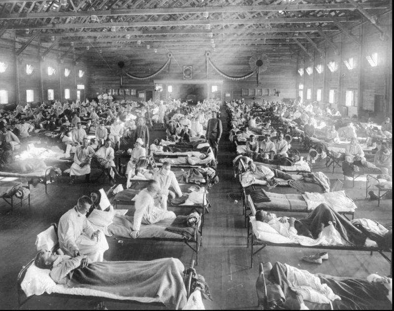 In this 1918 photograph, flu victims crowd into an emergency hospital at Camp Funston, a subdivision of Fort Riley in Kansas. The flu, which is believed to have originated in Kansas, killed at least 20 million people worldwide. (AP Photo/National Museum of Health, ho)