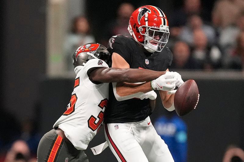 Tampa Bay Buccaneers cornerback Jamel Dean (35) breaks up a pass intended for Atlanta Falcons wide receiver Drake London (5) during the first half of an NFL football game Thursday, Oct. 3, 2024, in Atlanta. (AP Photo/John Bazemore)