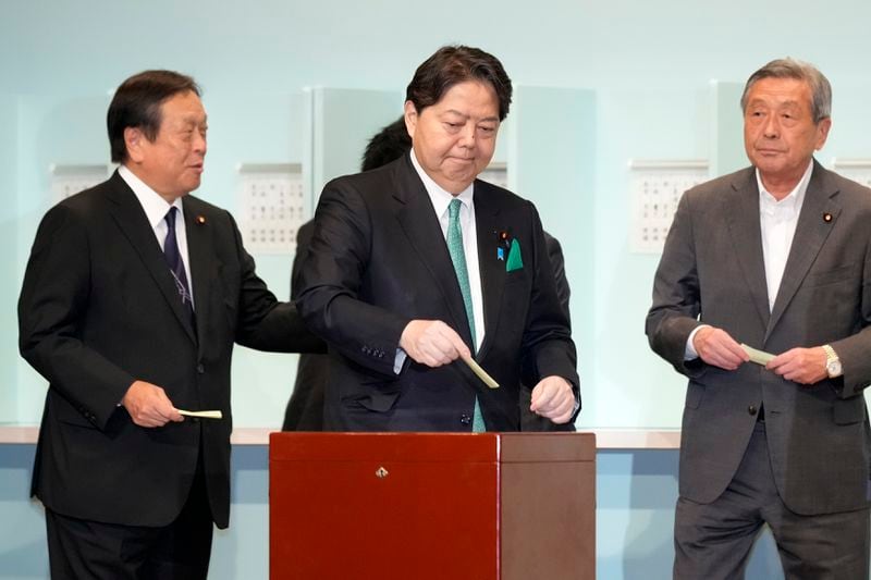 One of candidates, Yoshimasa Hayashi, center, casts his ballot at the Liberal Democratic Party's (LDP) leadership election Friday, Sept. 27, 2024, in Tokyo. (AP Photo/Hiro Komae, Pool)